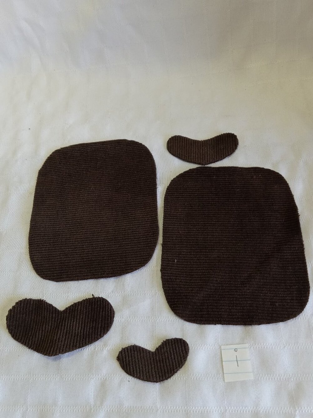 Two handmade elbow patches for sewing made of brown corduroy with hearts